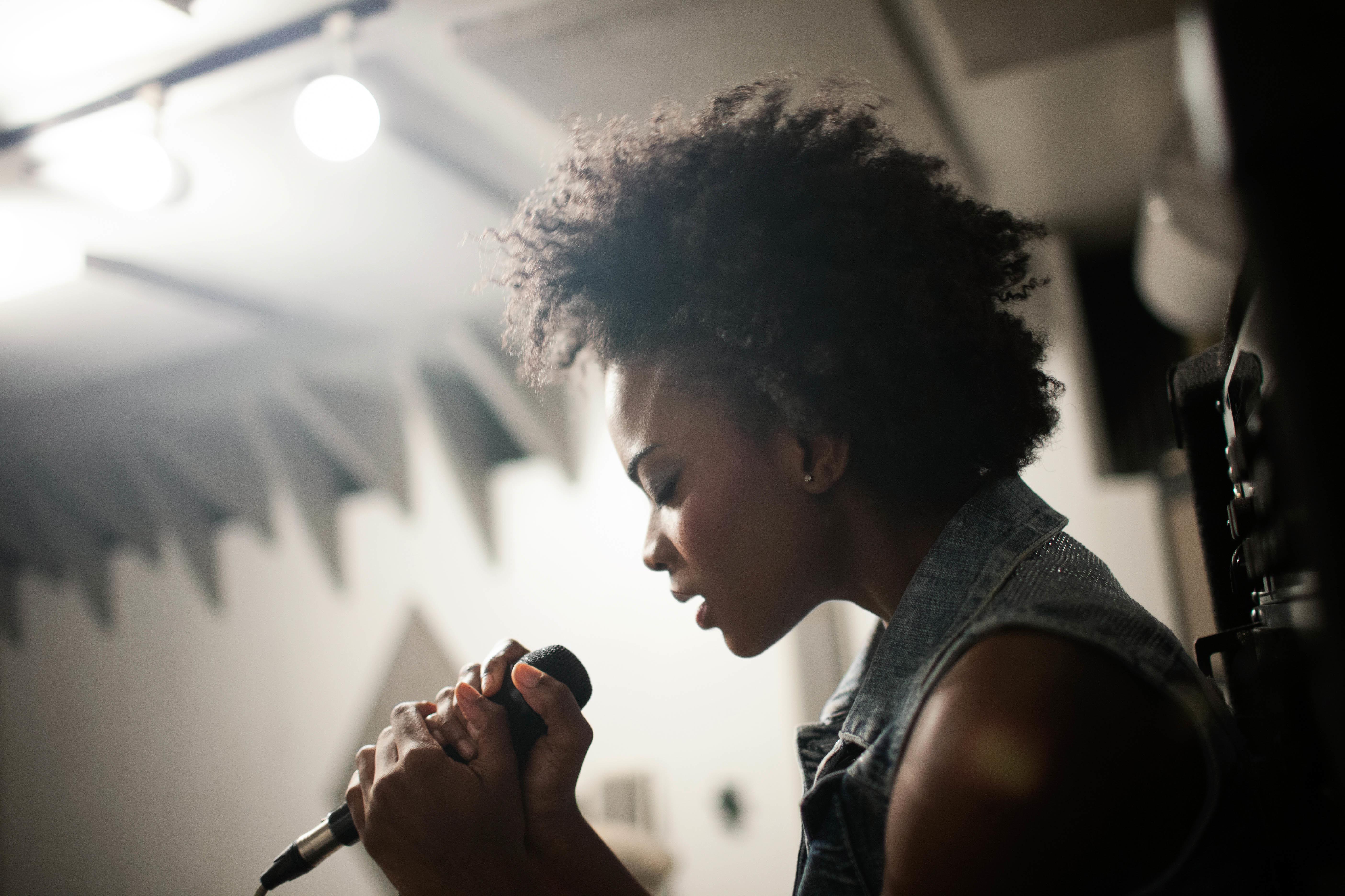 Close up of a woman singing into a microphone