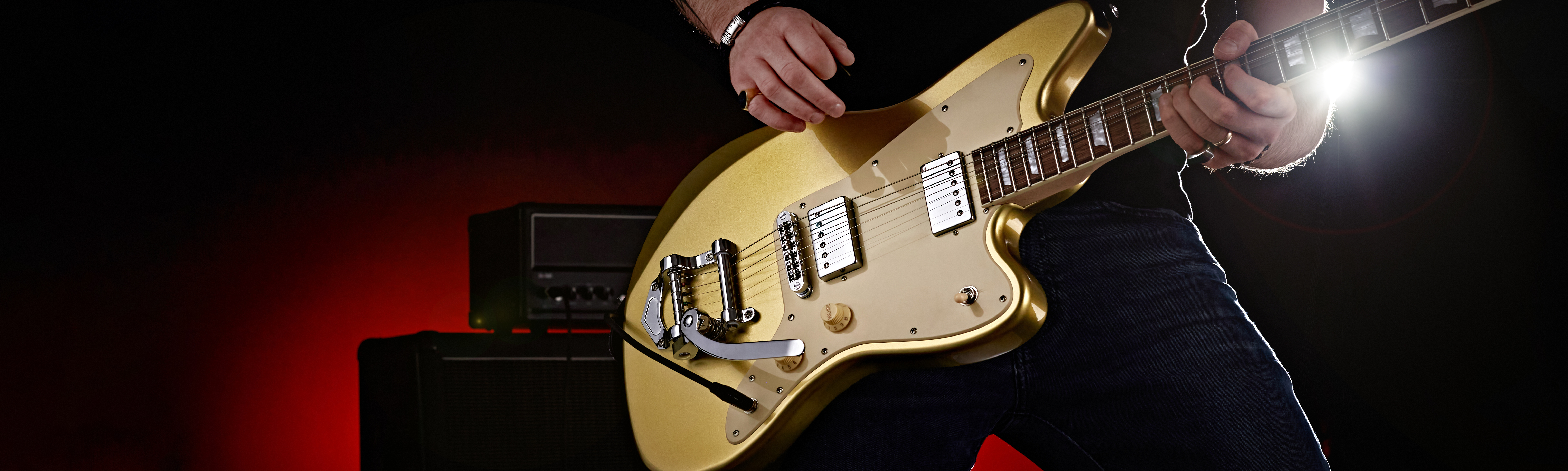 Close up product shot of a guitar being played by a man