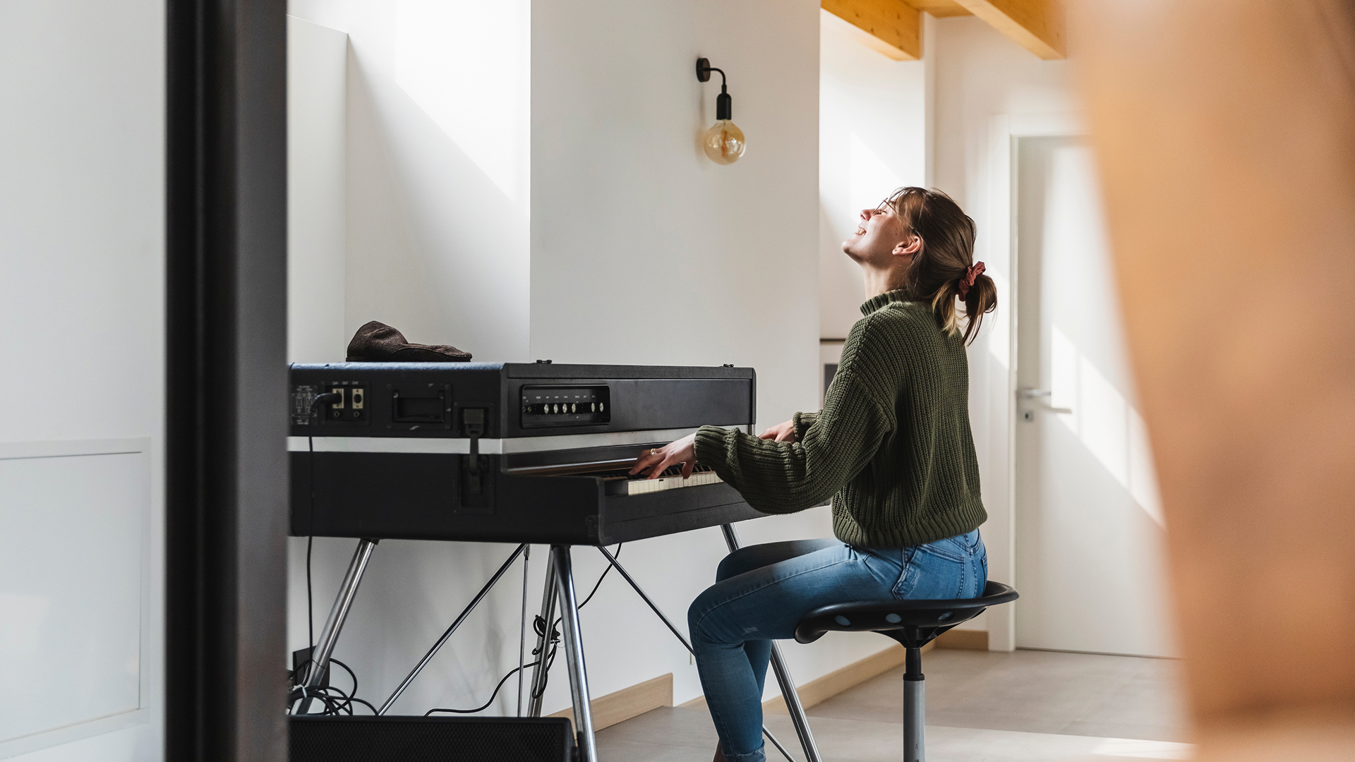 A girl playing a large electric keyboard